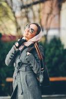 Happy young beautiful girl posing in the park photo