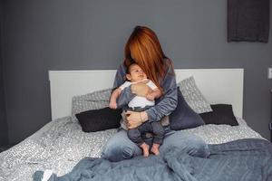 Mother with her baby in bedroom photo