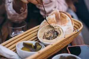 Fresh delicious hummus, pita bread and pickles cucumbers photo