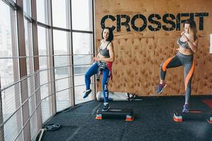 Two beautiful girls together in a fitness room photo