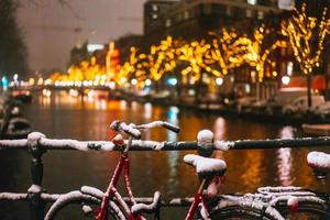 Bicycles Parked Along a Bridge Over the Canals of Amsterdam photo