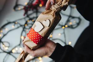 girl holding a Christmas gift in hand photo