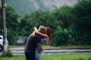beautiful couple hugging in the rain photo