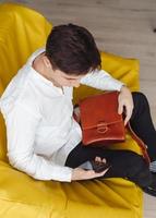 handsome guy with leather bag photo