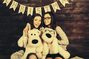 Two charming girls playing with Christmas toys photo