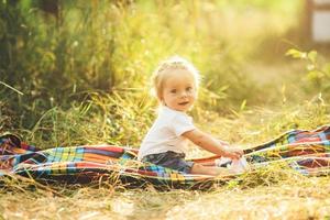 little girl sitting on the lawn photo