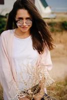 Beautiful, young girl posing on a wild seashore photo