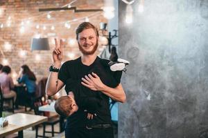 Dad is holding his little son in his arms photo
