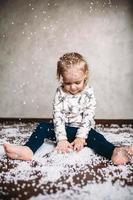 Little girl is playing with foam balls photo