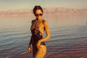 A young woman enjoying the natural mineral mud photo