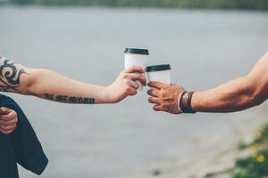 cheers using two cups of coffee photo