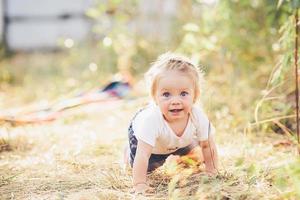 little girl crawling on the lawn photo