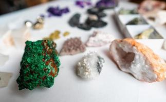 Collection of beautiful precious stones on white table. photo