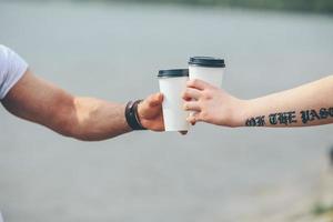 cheers using two cups of coffee photo