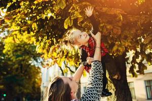 Mother and little daughter playing in a park photo