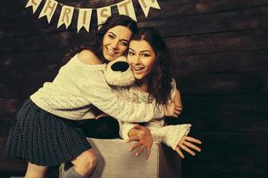 Family New Year's photos, one sister hugging each photo