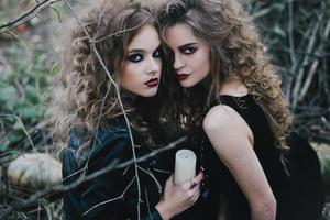 Two vintage witches gathered eve of Halloween photo