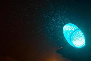 Traffic light on a snowy night photo