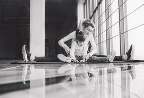 Mother and daughter makeing yoga in the gym photo