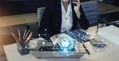 Cybersecurity and privacy concepts to protect data. Lock icon and internet network security technology. Businessman protecting personal data on smart phone with virtual screen interfaces. photo