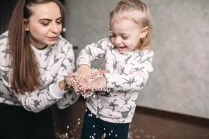 Mother and her daughter girl play in the room photo