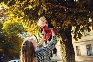 Mother and little daughter playing in a park photo