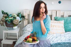 Girl holding the healthy fruit plate photo