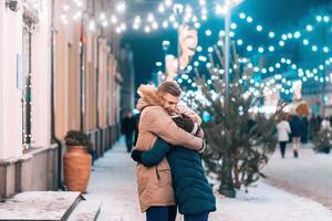 Outdoor close up portrait of young beautiful couple posing on street. photo