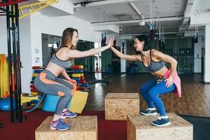 Two beautiful girls together in a fitness room photo