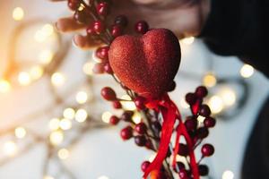 girl holding a red heart in the hands photo