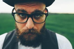 bearded man preparing to shave in the field photo