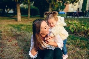 Mother and little daughter in a park photo