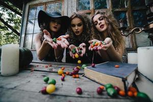 Three vintage witches perform magic ritual photo