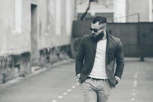 Stylish bearded man walks through the city photo