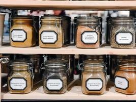 Cans with spices at the shelves photo