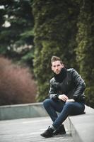 Man in jeans and black jacket photo