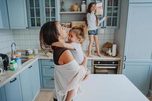 Happy family having fun in the kitchen photo