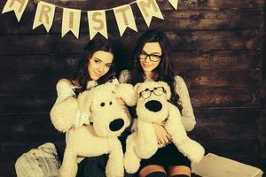 Two charming girls playing with Christmas toys photo