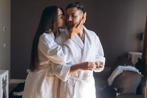 Happy couple enjoy each other's company in a hotel room. photo