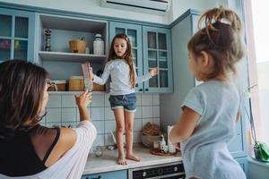 Happy family having fun in the kitchen photo