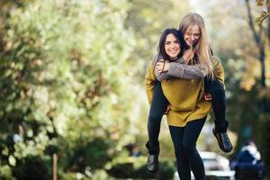 Two girls having fun in the park photo