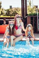 Happy mother and two daughters have fun photo