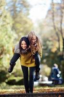 Two girls having fun in the park photo