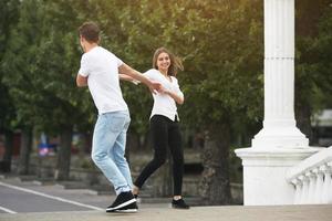 couple having fun on a bridge in the park photo