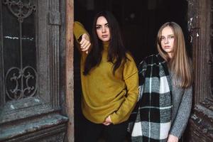 two beautiful women near the old doors photo