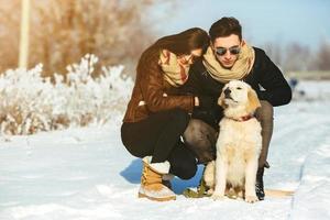 Young couple having fun in winter park photo