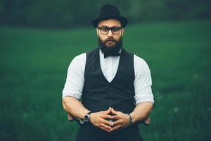 man with a beard, thinking in the field photo