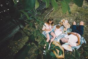 Happy family on lawn in the park photo