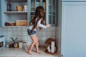 little girl opens the closet photo