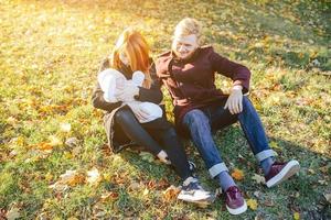 young family and newborn son in autumn park photo